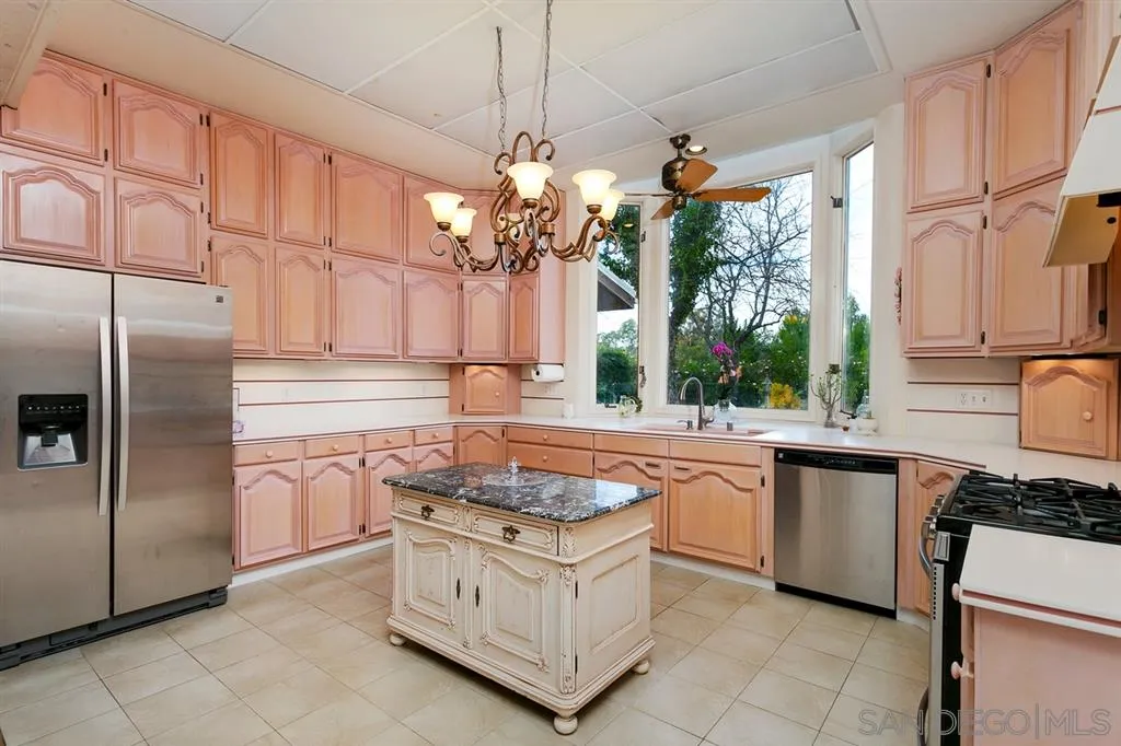 1154 Capra Way Fallbrook, CA 92028 - Photo 10 of 25 a kitchen with stainless steel appliances granite countertop a sink a stove and a refrigerator