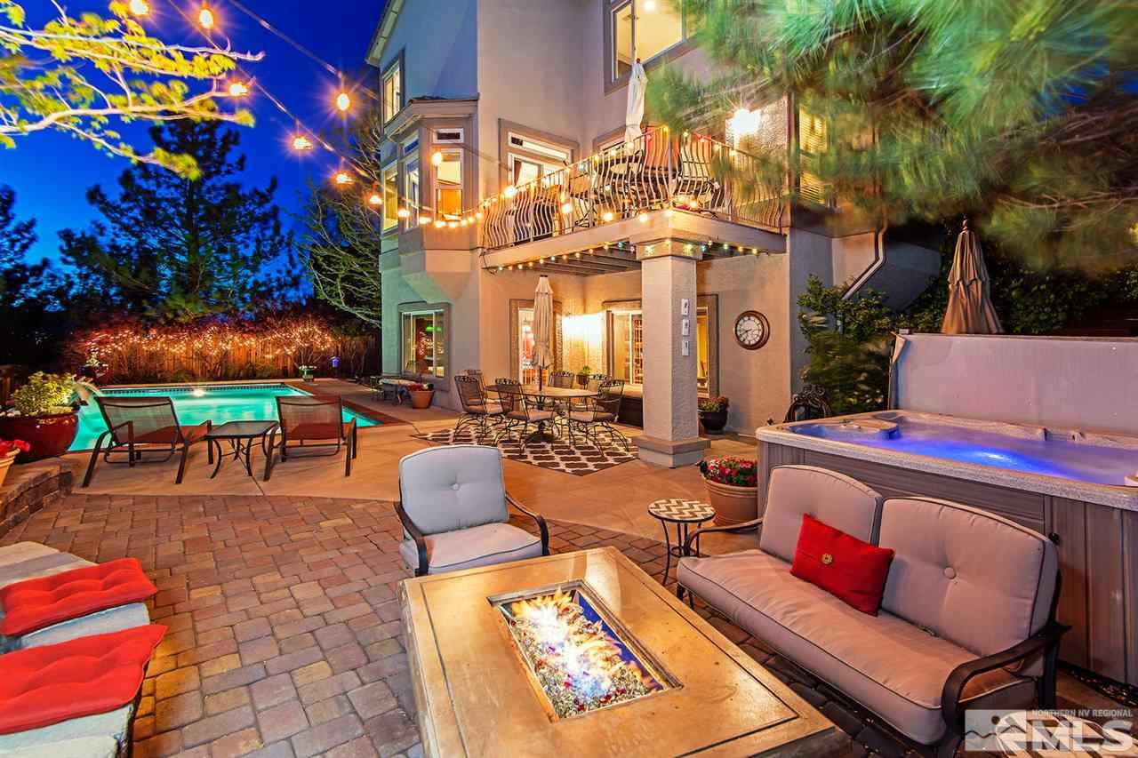 4870 East Creek Ridge Trail Reno, NV 89519 - Photo 1 of 25 a outdoor space with patio fireplace and a potted plant