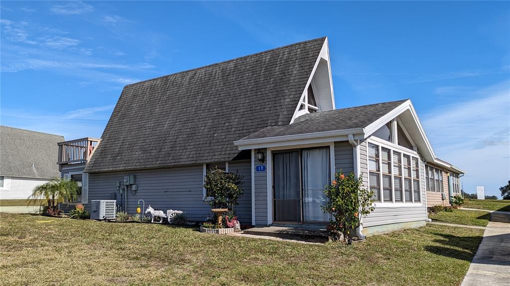 10301 Highway 27, Unit 17 Clermont, FL 34711 - Photo 1 of 19 a front view of a house with garden