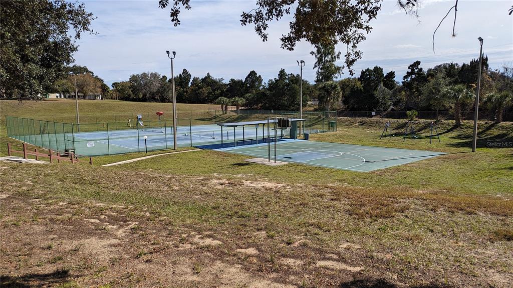 10301 Highway 27, Unit 17 Clermont, FL 34711 - Photo 13 of 19 a view of a field with trees in the background