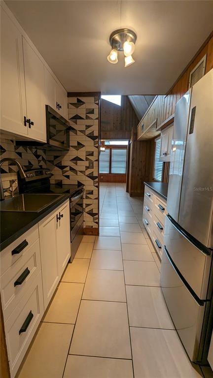 10301 Highway 27, Unit 17 Clermont, FL 34711 - Photo 5 of 19 a kitchen with stainless steel appliances granite countertop a stove a sink and a refrigerator