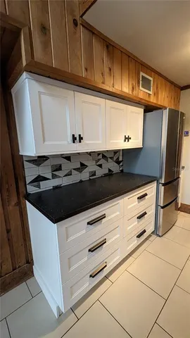 a kitchen with stainless steel appliances a stove a microwave and a refrigerator