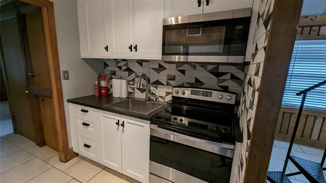 a kitchen with stainless steel appliances granite countertop a stove and a sink