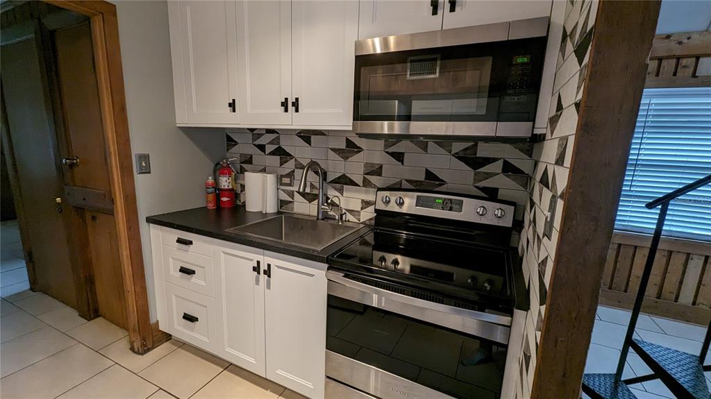 10301 Highway 27, Unit 17 Clermont, FL 34711 - Photo 7 of 19 a kitchen with stainless steel appliances granite countertop a stove and a sink