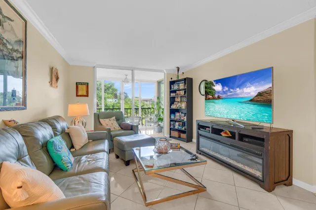 a dining room with furniture and a floor to ceiling window