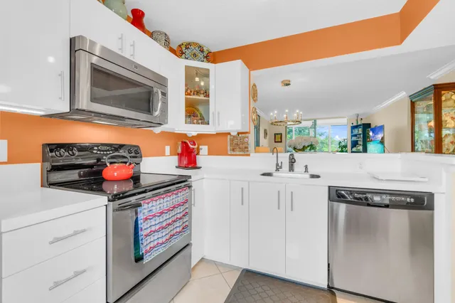 a kitchen with stainless steel appliances a sink and cabinets