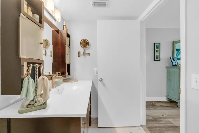 a bathroom with a sink vanity and a mirror