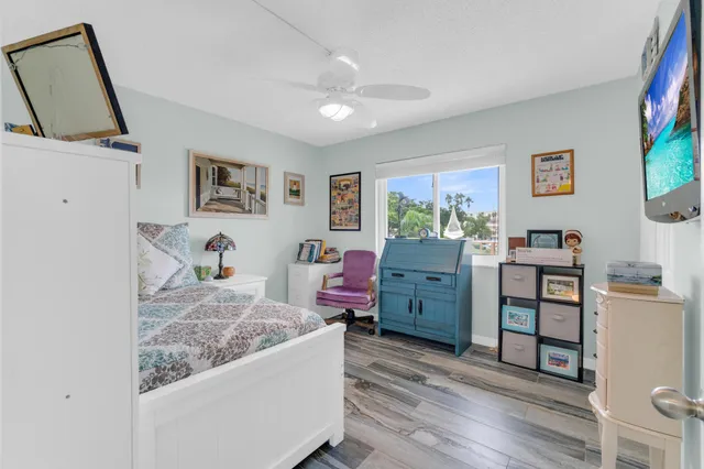 a dining room with a couch and a painting on the wall