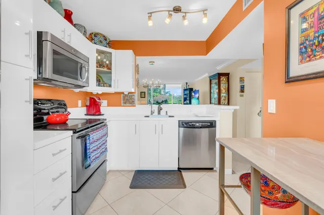 a kitchen with stainless steel appliances granite countertop a refrigerator and a stove