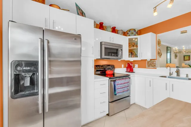 a kitchen with granite countertop stainless steel appliances and counter space
