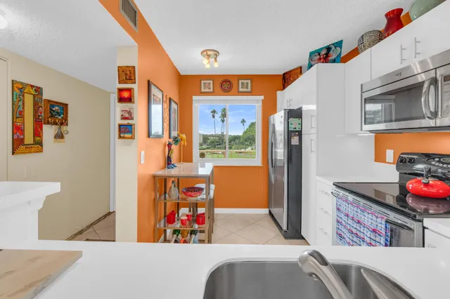 a kitchen with stainless steel appliances granite countertop a refrigerator and a stove