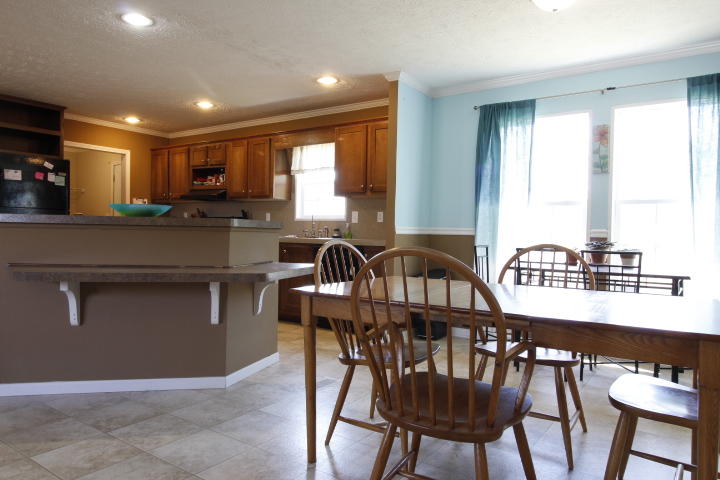 551 Merrimac Road Blacksburg, VA 24060 - Photo 3 of 12 a kitchen with stainless steel appliances granite countertop a stove a sink a table and chairs