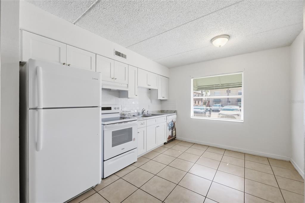 705 Michigan Court, Unit 14 St. Cloud, FL 34769 - Photo 12 of 45 a kitchen with stainless steel appliances a refrigerator sink and cabinets