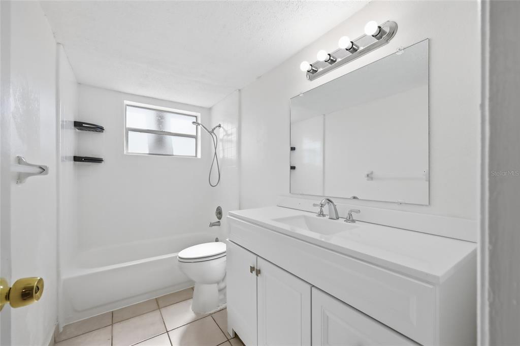 705 Michigan Court, Unit 14 St. Cloud, FL 34769 - Photo 16 of 45 a bathroom with a sink a toilet and shower