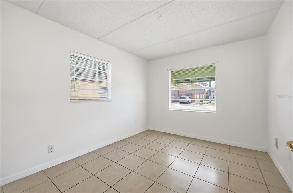 705 Michigan Court, Unit 14 St. Cloud, FL 34769 - Photo 17 of 45 an empty room with windows