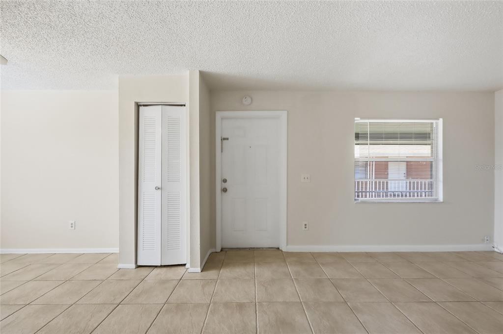 705 Michigan Court, Unit 14 St. Cloud, FL 34769 - Photo 21 of 45 a view of an empty room with window and chandelier fan