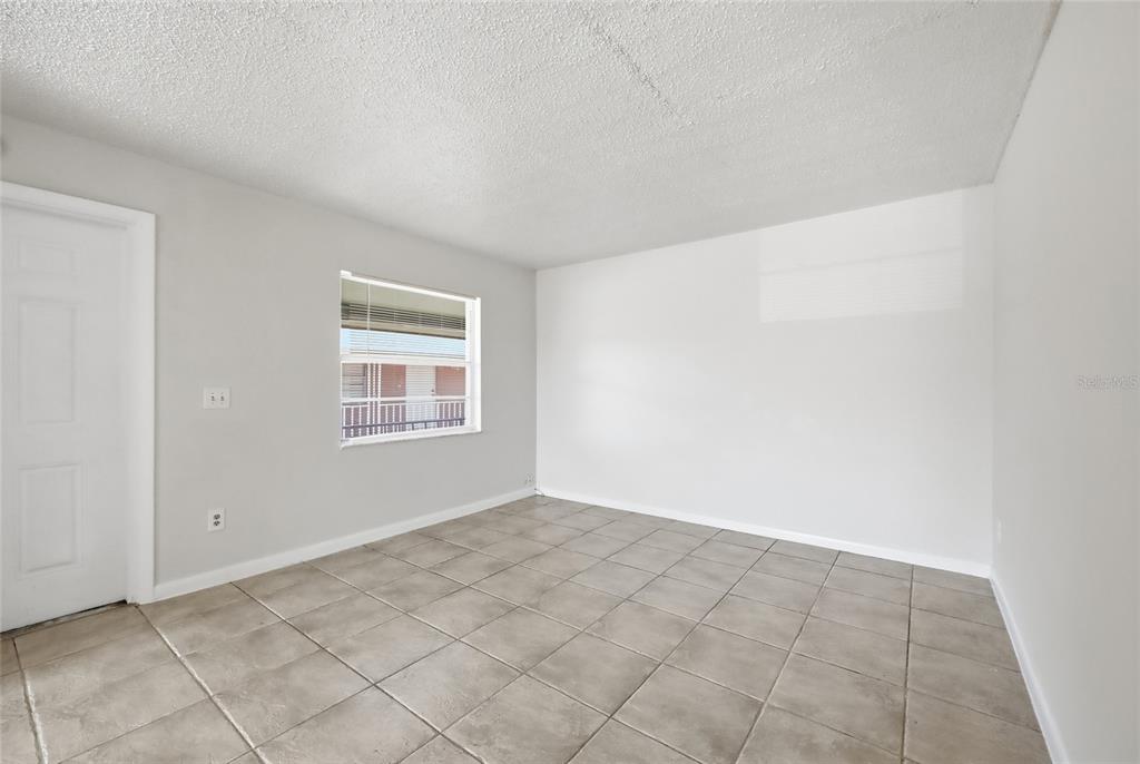 705 Michigan Court, Unit 14 St. Cloud, FL 34769 - Photo 22 of 45 a view of an empty room with a window