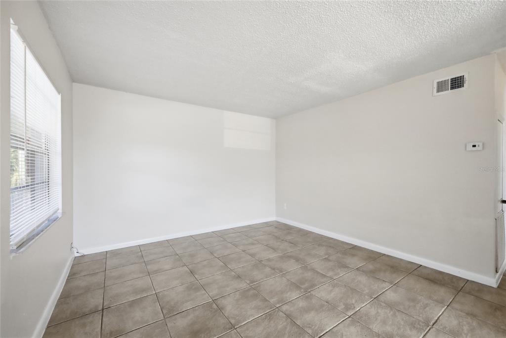 705 Michigan Court, Unit 14 St. Cloud, FL 34769 - Photo 23 of 45 an empty room with a natural light