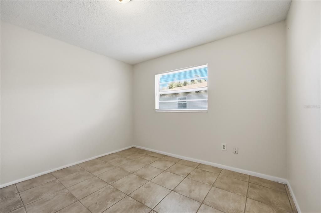 705 Michigan Court, Unit 14 St. Cloud, FL 34769 - Photo 32 of 45 an empty room with a window