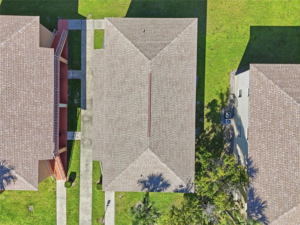 705 Michigan Court, Unit 14 St. Cloud, FL 34769 - Photo 34 of 45 aerial view of a house with a yard and potted plants