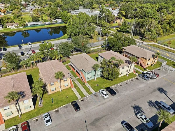 an aerial view of a house with a yard basket ball court and outdoor seating