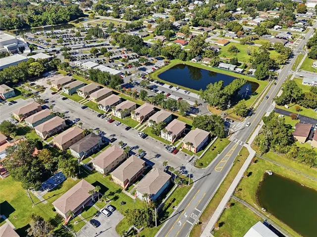 an aerial view of residential houses with yard