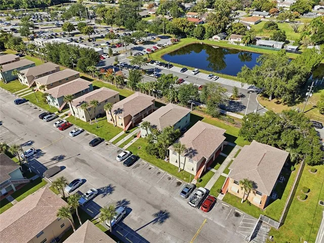 an aerial view of multiple houses with yard