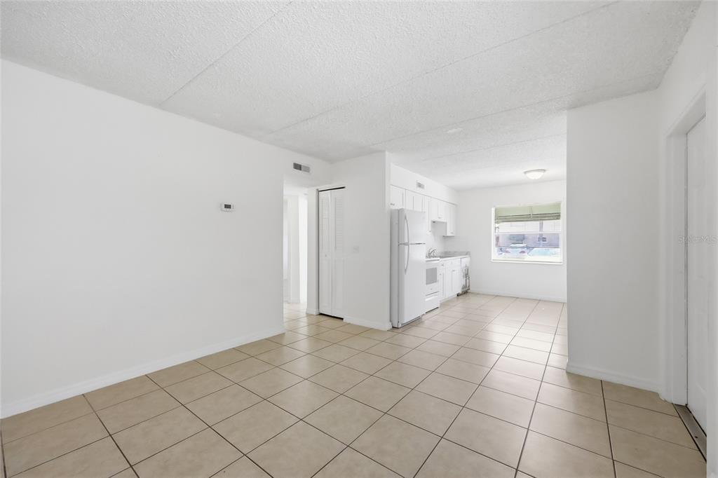 705 Michigan Court, Unit 14 St. Cloud, FL 34769 - Photo 9 of 45 a view of a kitchen with white cabinet and a refrigerator