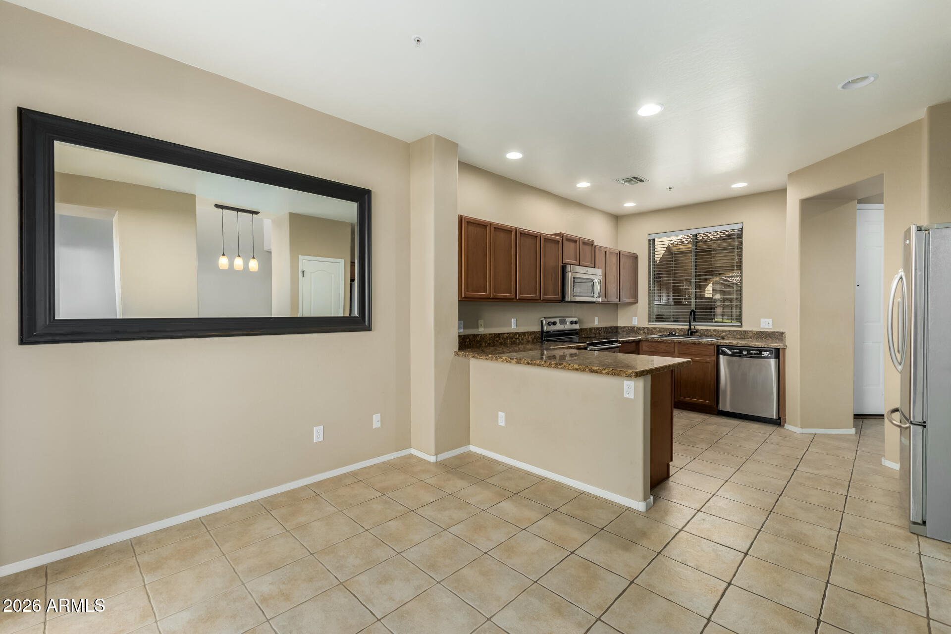 5415 East McKellips Road, Unit 106 Mesa, AZ 85215 - Photo 13 of 45 a kitchen with a refrigerator and a stove top oven