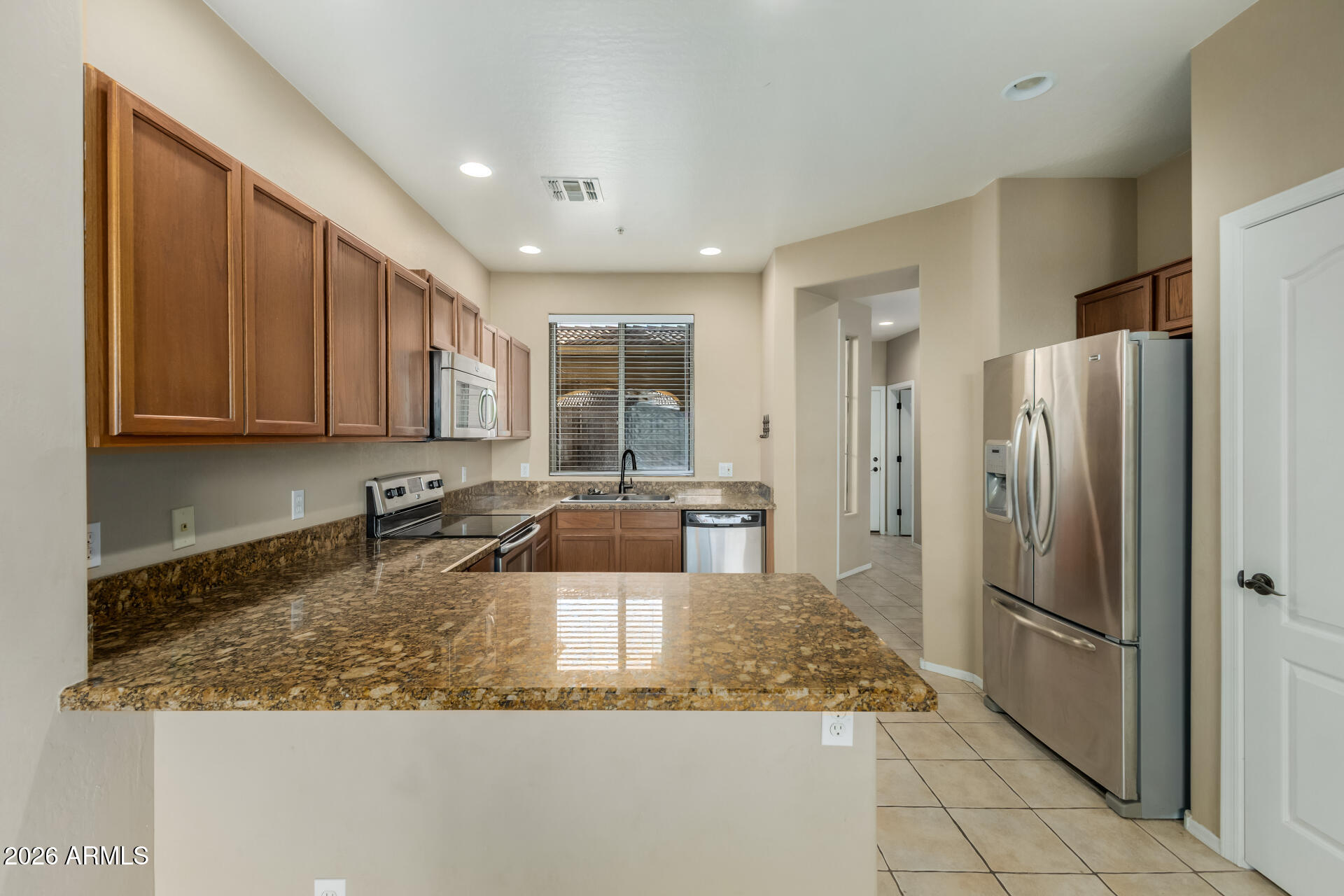 5415 East McKellips Road, Unit 106 Mesa, AZ 85215 - Photo 16 of 45 a kitchen with a refrigerator a sink and cabinets