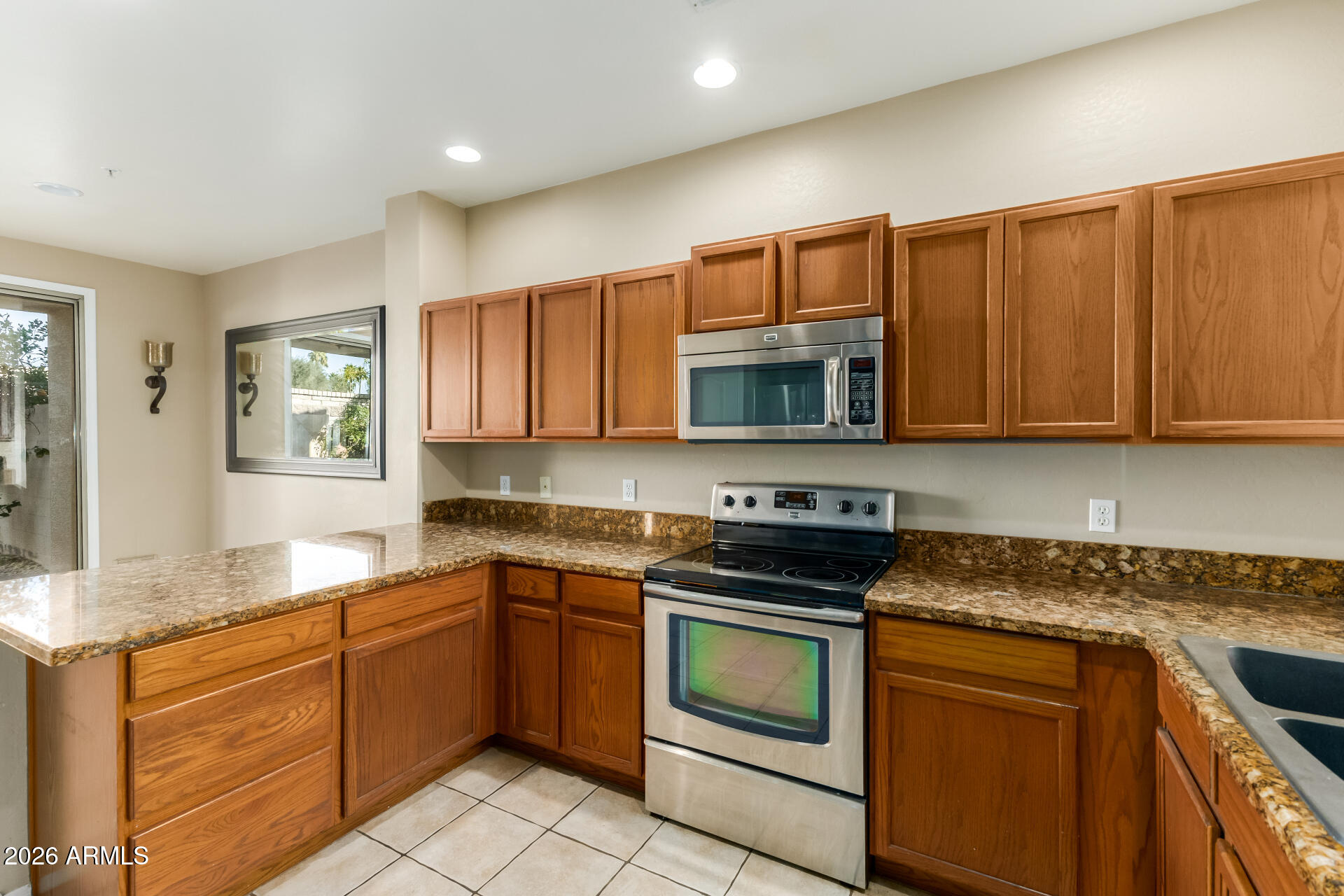 5415 East McKellips Road, Unit 106 Mesa, AZ 85215 - Photo 18 of 45 a kitchen with granite countertop cabinets stainless steel appliances and a sink