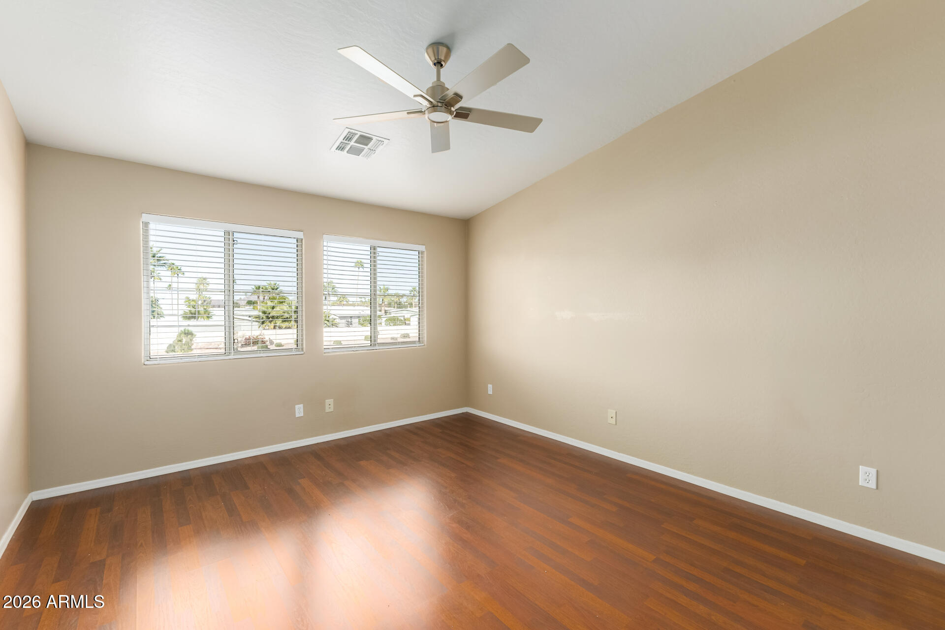 5415 East McKellips Road, Unit 106 Mesa, AZ 85215 - Photo 23 of 45 an empty room with wooden floor and windows