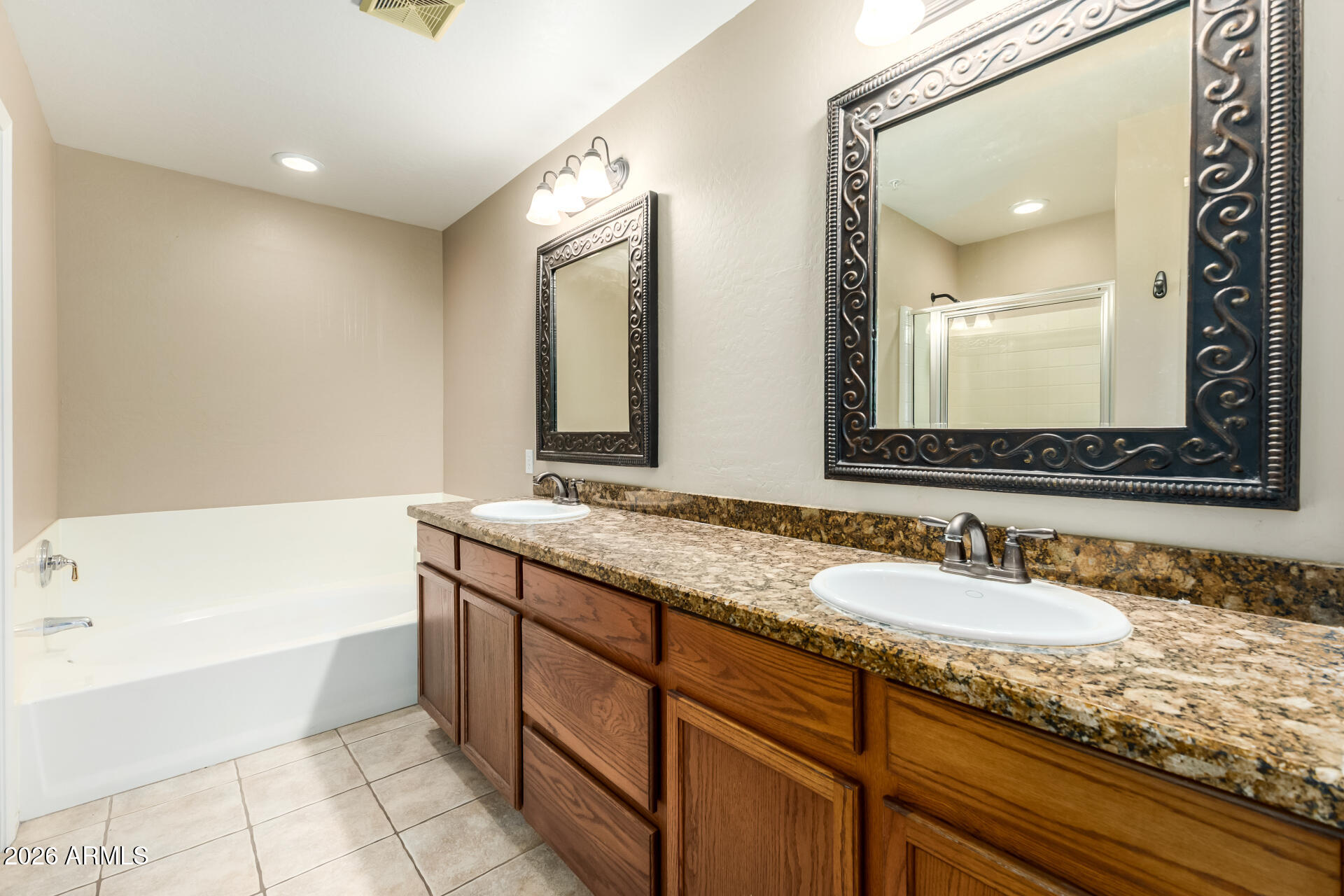 5415 East McKellips Road, Unit 106 Mesa, AZ 85215 - Photo 26 of 45 a bathroom with a granite countertop sink mirror and bathtub