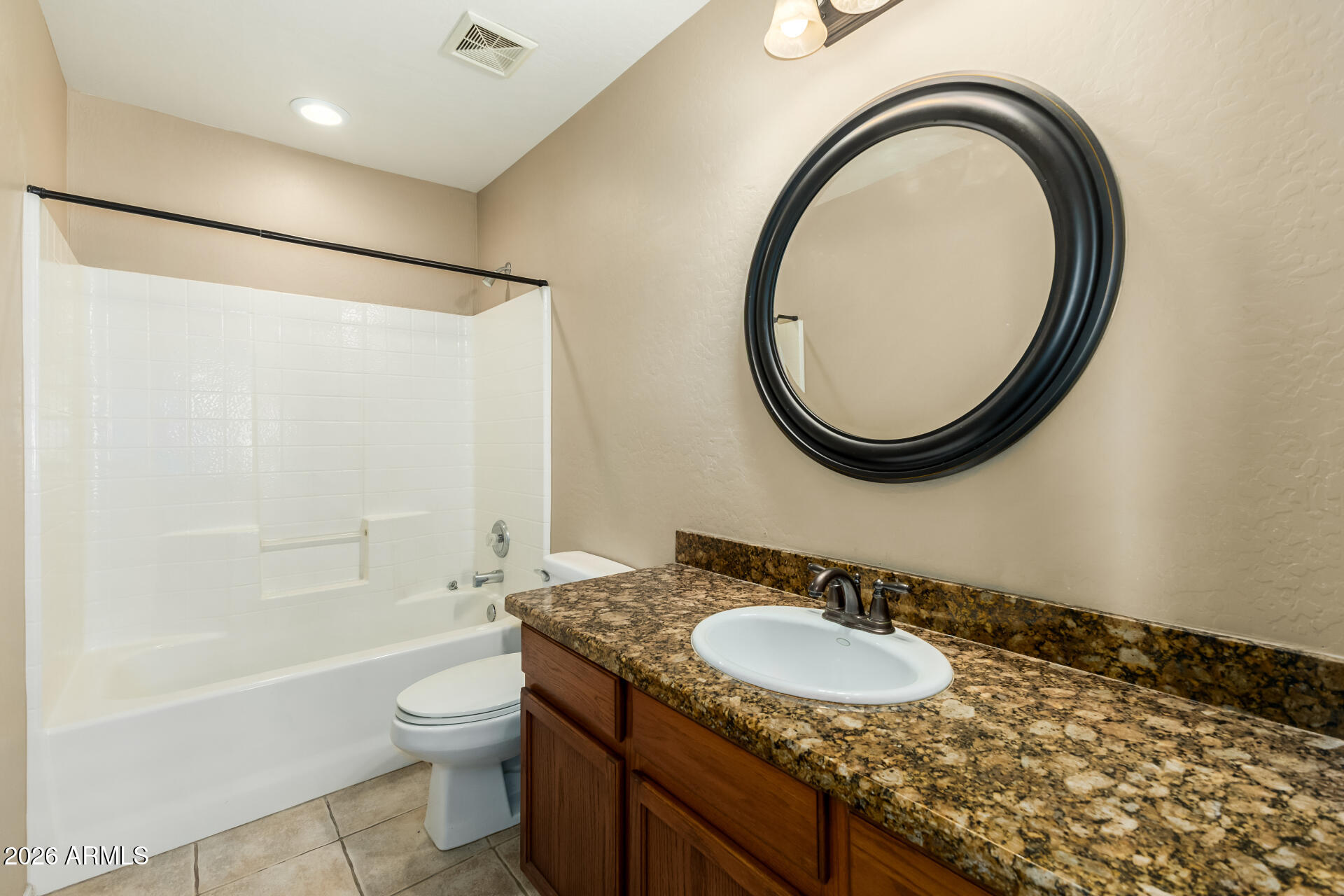 5415 East McKellips Road, Unit 106 Mesa, AZ 85215 - Photo 32 of 45 a bathroom with a granite countertop sink a toilet and a mirror