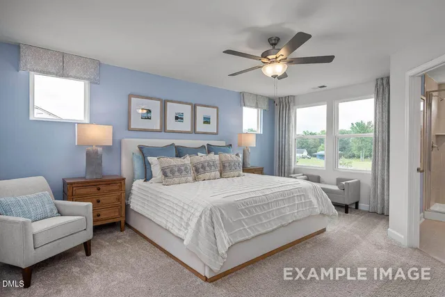 a bedroom with a large bed and a chandelier