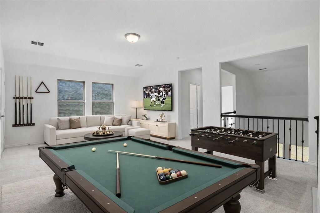 537 Oakmoss Street Little Elm, TX 76227 - Photo 17 of 39 a living room with furniture pool table and a window