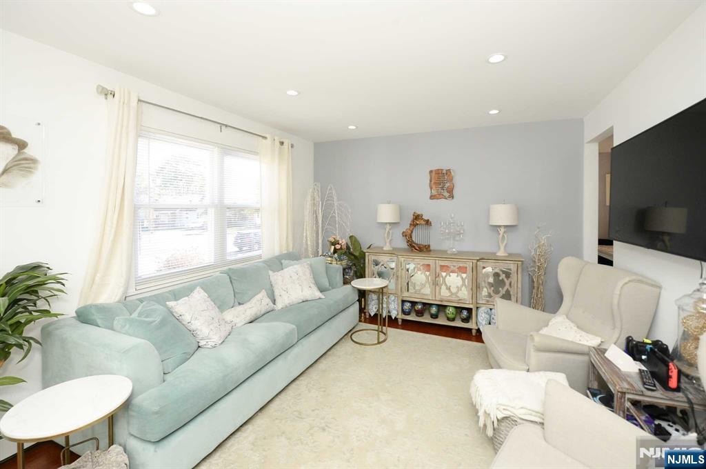 38-41 Taylor Road Fair Lawn, NJ 07410 - Photo 2 of 15 a living room with furniture and a flat screen tv
