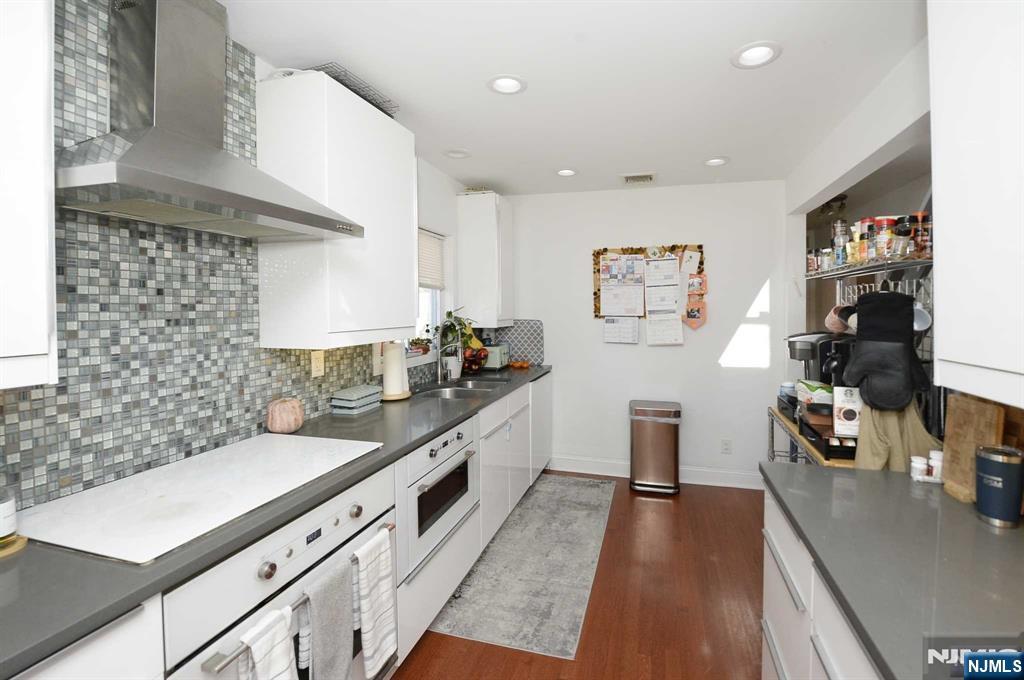 38-41 Taylor Road Fair Lawn, NJ 07410 - Photo 4 of 15 a kitchen with stainless steel appliances a sink stove and cabinets