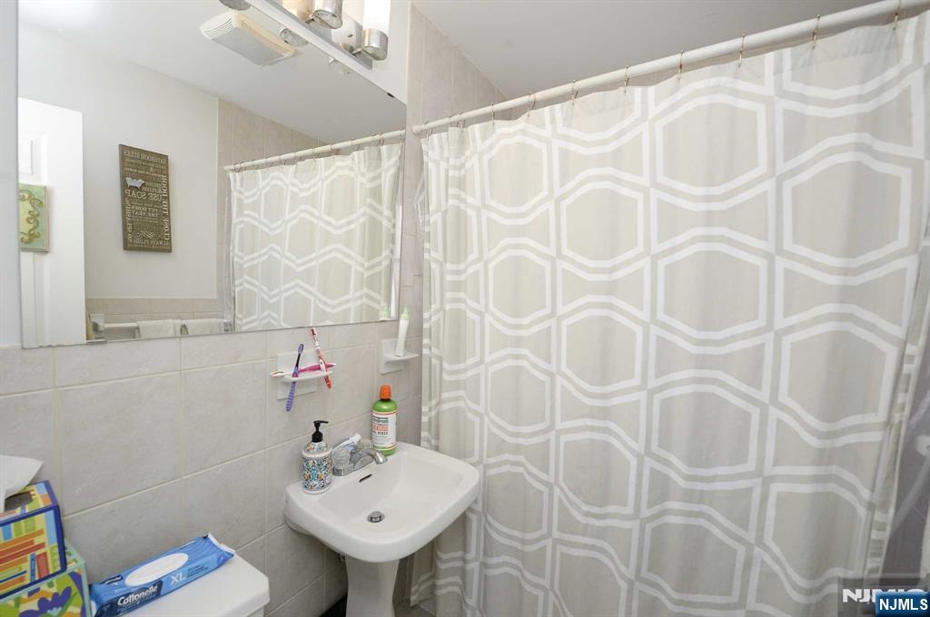 38-41 Taylor Road Fair Lawn, NJ 07410 - Photo 7 of 15 a bathroom with a sink and a mirror