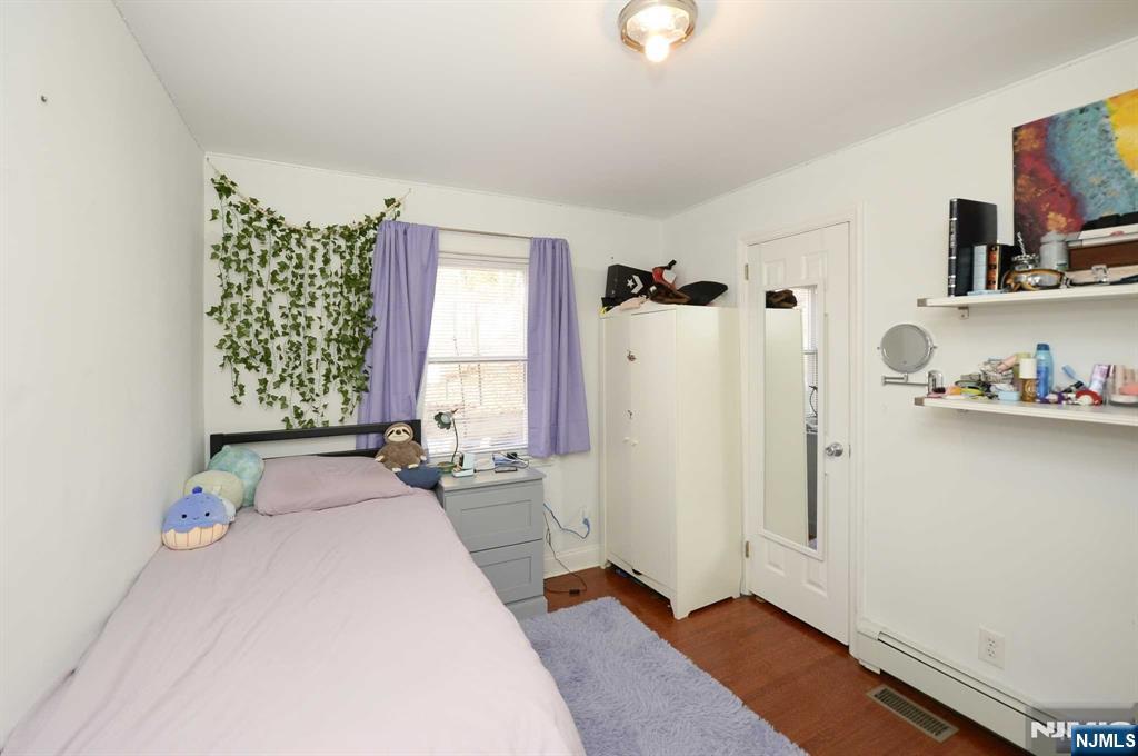 38-41 Taylor Road Fair Lawn, NJ 07410 - Photo 8 of 15 a bedroom with a bed and a window