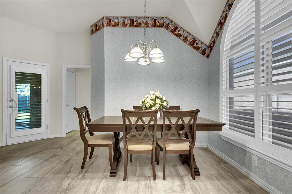 5409 Deer Brook Road Garland, TX 75044 - Photo 12 of 31 a view of a dining room with furniture a chandelier and wooden floor