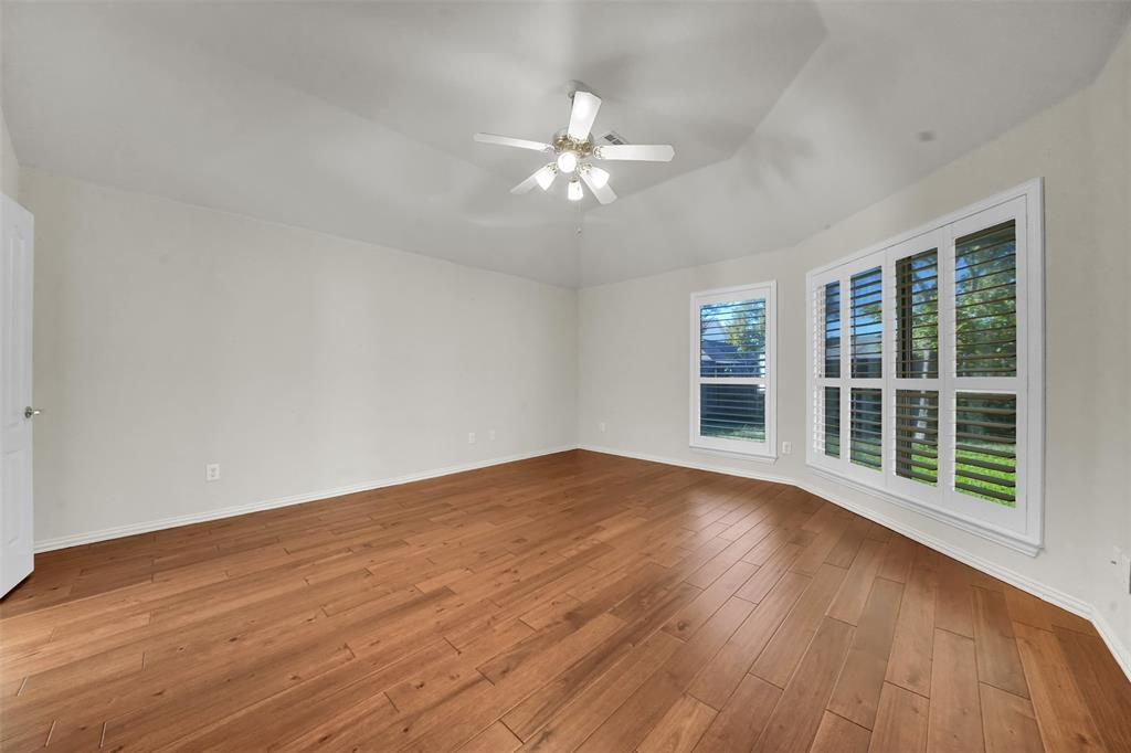 5409 Deer Brook Road Garland, TX 75044 - Photo 15 of 31 a view of empty room with wooden floor and fan