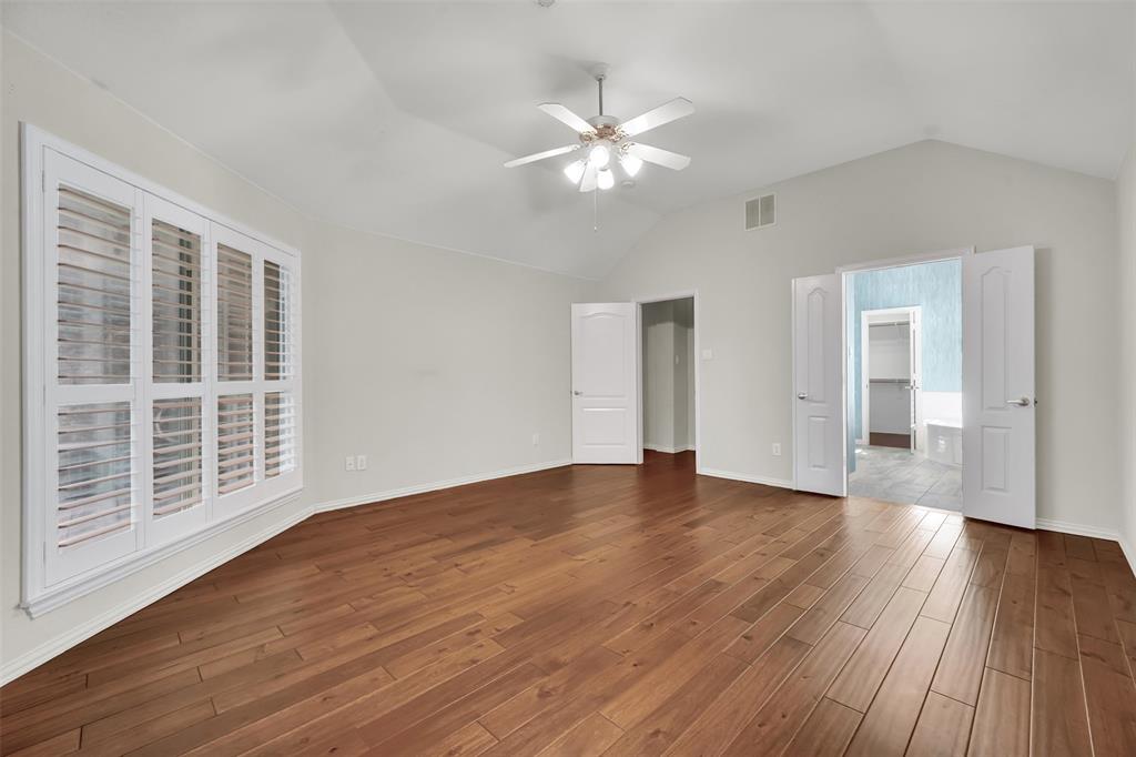 5409 Deer Brook Road Garland, TX 75044 - Photo 16 of 31 a view of an empty room with wooden floor and windows
