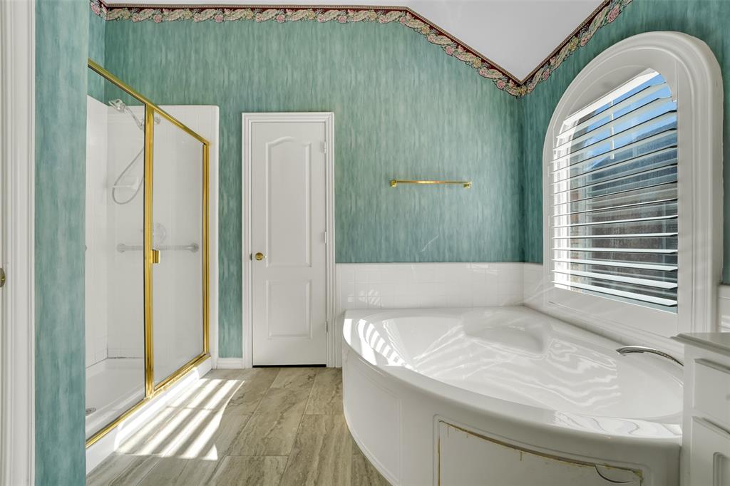 5409 Deer Brook Road Garland, TX 75044 - Photo 18 of 31 a bathroom with a tub and shower