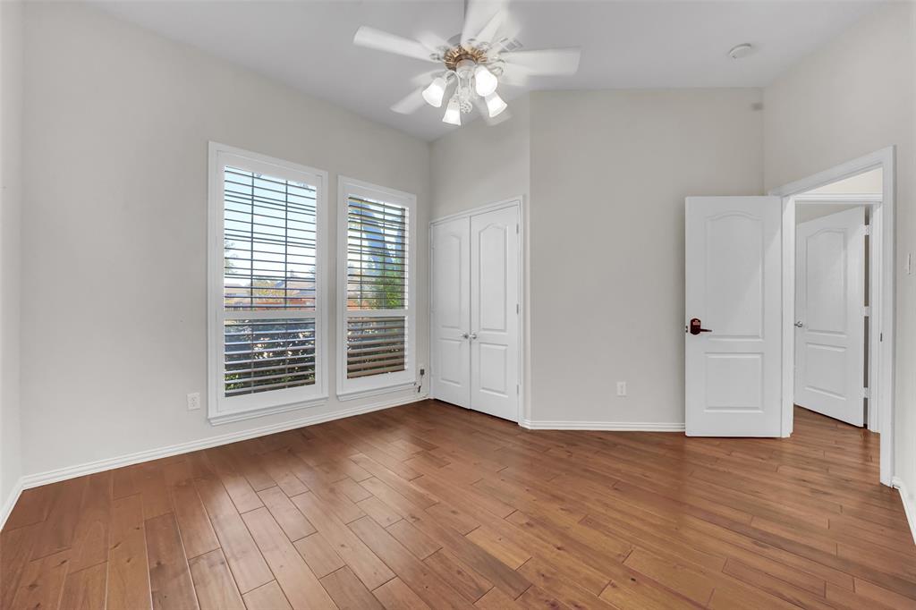5409 Deer Brook Road Garland, TX 75044 - Photo 21 of 31 a view of an empty room with wooden floor and a window