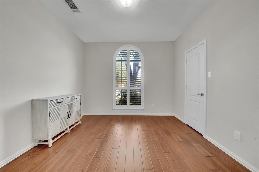 5409 Deer Brook Road Garland, TX 75044 - Photo 24 of 31 wooden floor in an empty room with a window