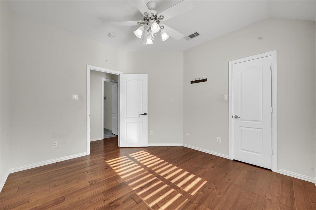 5409 Deer Brook Road Garland, TX 75044 - Photo 27 of 31 a view of a room with wooden floor and a ceiling fan