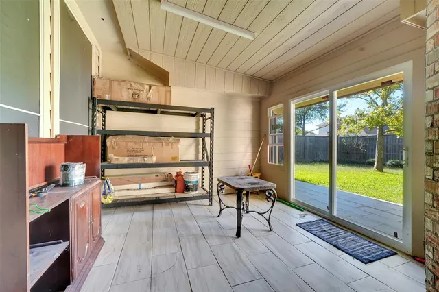a view of a backyard with table and chairs and wooden fence