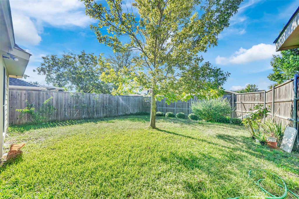 5409 Deer Brook Road Garland, TX 75044 - Photo 30 of 31 a view of a backyard with table and chairs and wooden fence