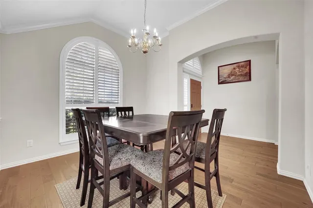 a view of a dining room with furniture and chandelier